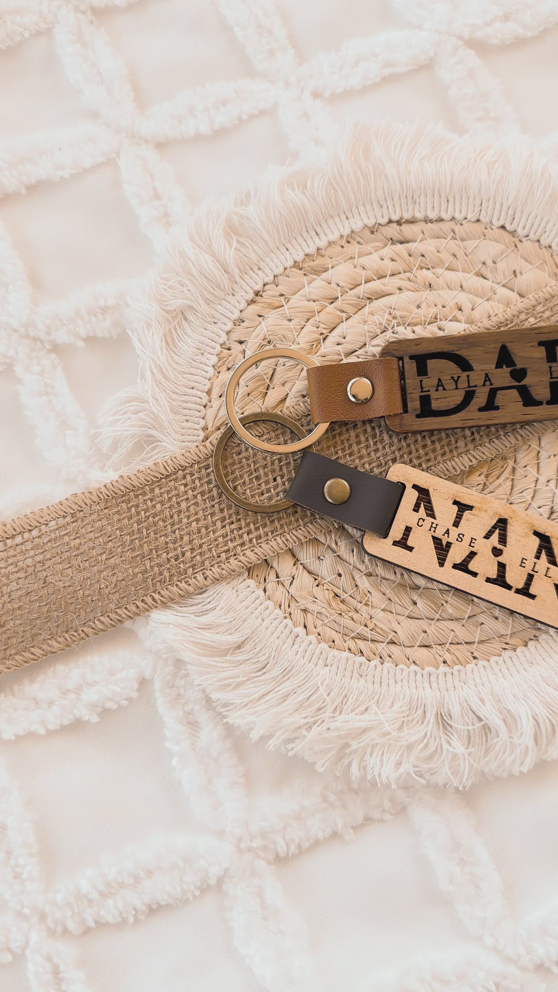 Two leather keychains with custom engraved text on a textured wooden surface, personalised key ring, gift for dad