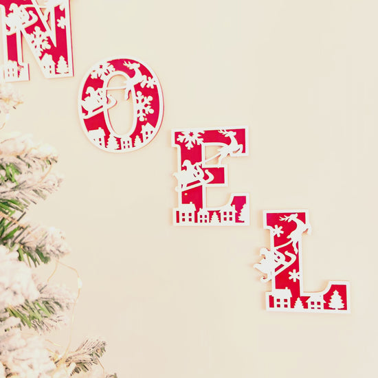 Christmas themed decorative wall letters with snowflake, reindeer and santa and his sleigh designs, 3D layered acrylic and wood letters alphabet for personalised custom name or phrase Christmas decor